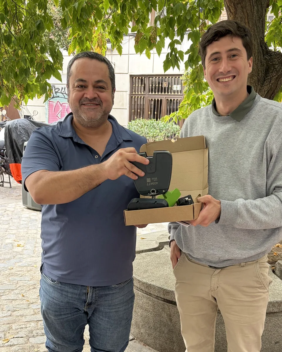 Benjamin Mazin of Nofence handing the first C2.5 virtual-fencing collar to Marcelo Chávez García in Madrid